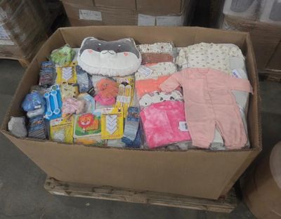 a cardboard box full of baby clothes and other items