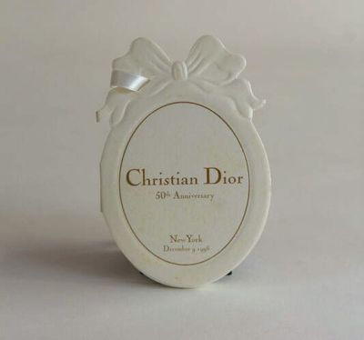 a small white box with a bow on top of it