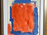 a painting of an orange and blue square on a wooden surface