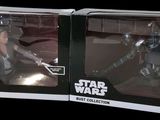 two star wars action figures are in a box on a black background