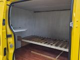 a yellow van with a bed inside of it