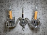 two wall sconces that are attached to a wall