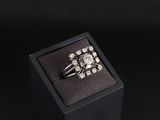 une image représentant une bague en diamant dans un écrin noir sur fond noir