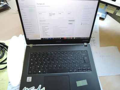 a laptop computer sitting on top of a wooden table