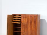an image of a wooden cabinet with drawers and shelves