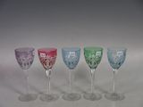 several different colored wine glasses are lined up in a row