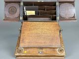 an old wooden box with a key in it sitting on a table
