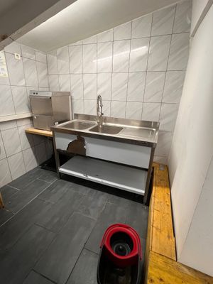 a kitchen with a sink and a stove in it