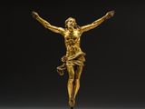 an image of a gold statue of jesus on a cross