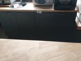 a small kitchen with a microwave, toaster and toaster on the counter