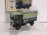 a green toy truck with a box on top of it