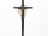 a black cross with a heart on top of it on a white background