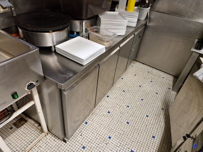 a kitchen with a lot of stainless steel counter tops