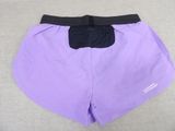 a close up of a pair of purple shorts with black waistbands