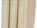 three books are stacked on top of each other on a white surface