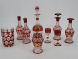 a group of red and white glass vases and wine glasses