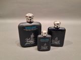 three black bottles of perfume sitting on top of a table