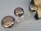 three salt and pepper shakers sitting on a table