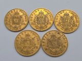 four gold coins with a coat of arms on them sitting on a table