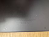 the back of a laptop with a small screen on top of a wooden table