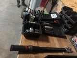 a lot of tools sitting on a table in a garage