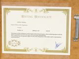 a certificate on a piece of paper next to a key
