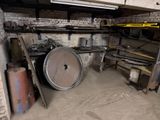 a large metal barrel sitting in a dirty room
