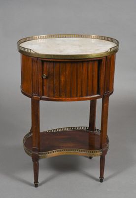 a small round table with a marble top and brass trim