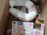 a baby in a box with a pillow and other toys