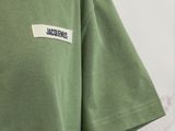 the back of a green t - shirt with a small patch on the chest