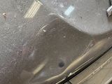 a close up of a car ' s hood with a wrench on it