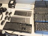 a computer desk with a keyboard, mouse, mouse pad, and other items on it