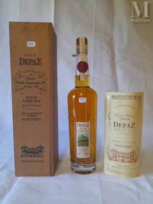 a bottle of depaz next to a box of wine