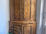 a wooden cabinet in the corner of a room