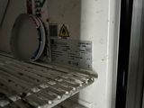 a dirty shelf in the refrigerator with a plate on it