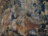 a tapestry with a picture of a man and a woman in a bed