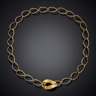 a gold necklace on a black background