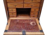 an old wooden chest of drawers with a door open