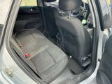 the back seat of a car with the door open and the passenger seat down