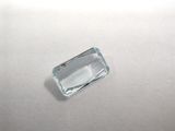a close up of an aquamarine stone on a white surface