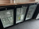 a small bar with a lot of bottles on top of it