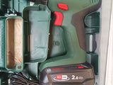 a cordless drill in a green box with a charger