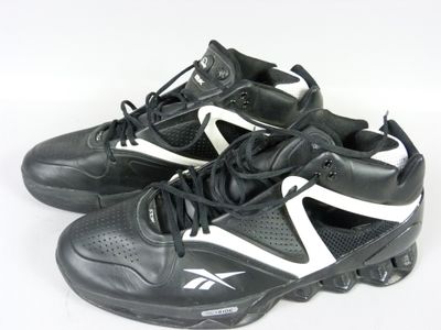 pair of black and white athletic shoes on a white surface