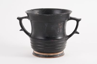 a black vase with two handles on a white background