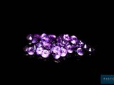 a pile of purple crystals on a black background