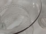 a glass bowl with a spoon in it on a table