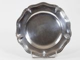 an antique silver plate on a stand on a white background