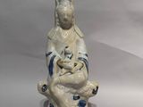 a figurine of a woman holding a cat
