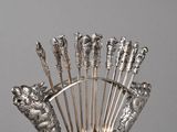 a silver plate with a bunch of forks in it