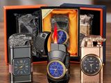 three different types of watches and a lighter in a box